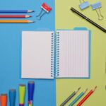 colorful pens and stationaries on blue and yellow surface