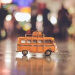 selective focus photography of yellow school bus scale model