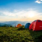 photo of pitched dome tents overlooking mountain ranges
