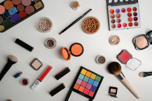an assortment of beauty products on a white surface