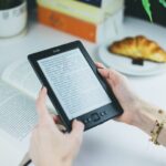 person holding kindle e book reader